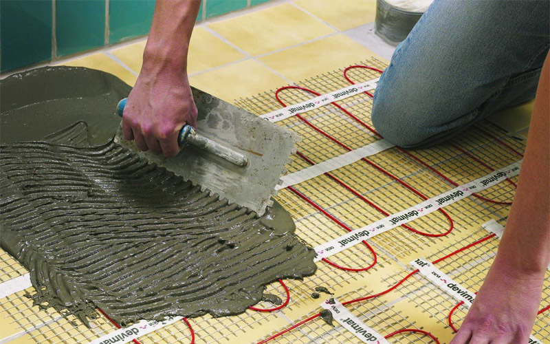 Laying tiles on mats